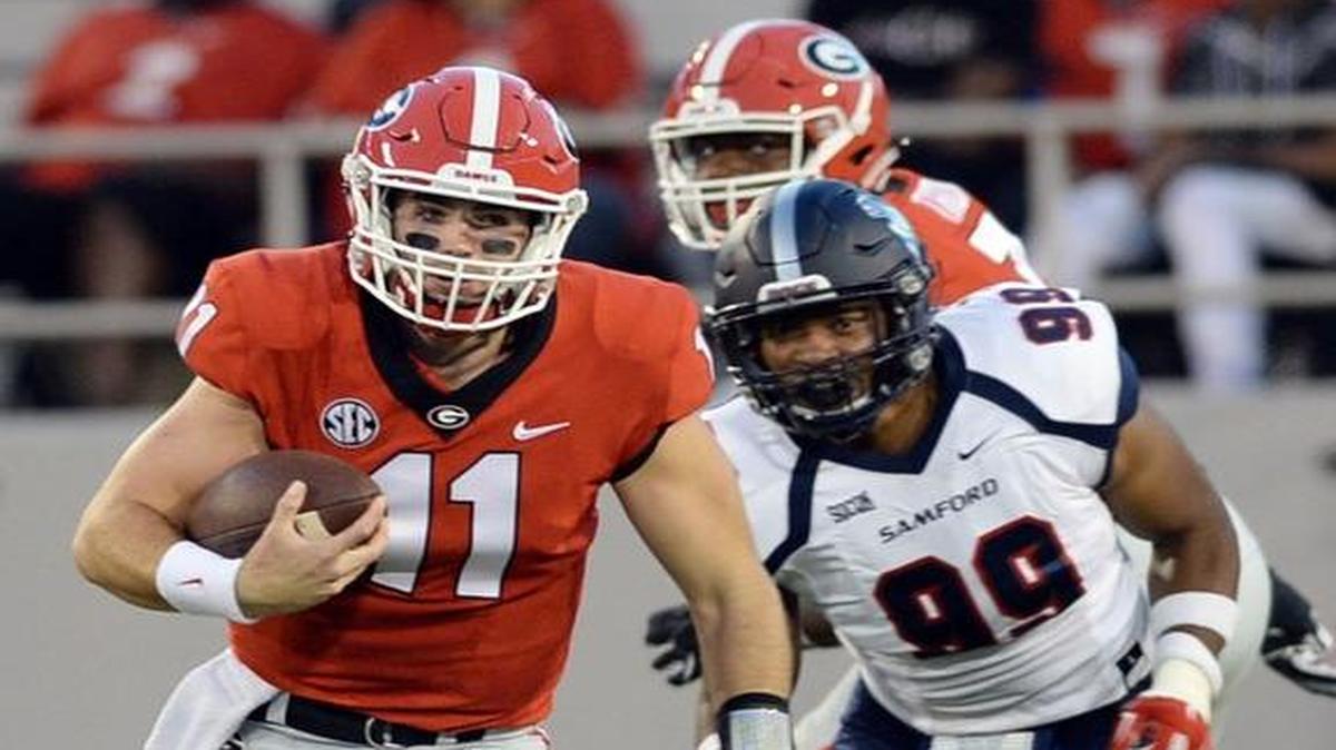 After breaking free from a potential sack, Georgia quarterback Jake Fromm (11) nearly rushes for a first down against Samford.