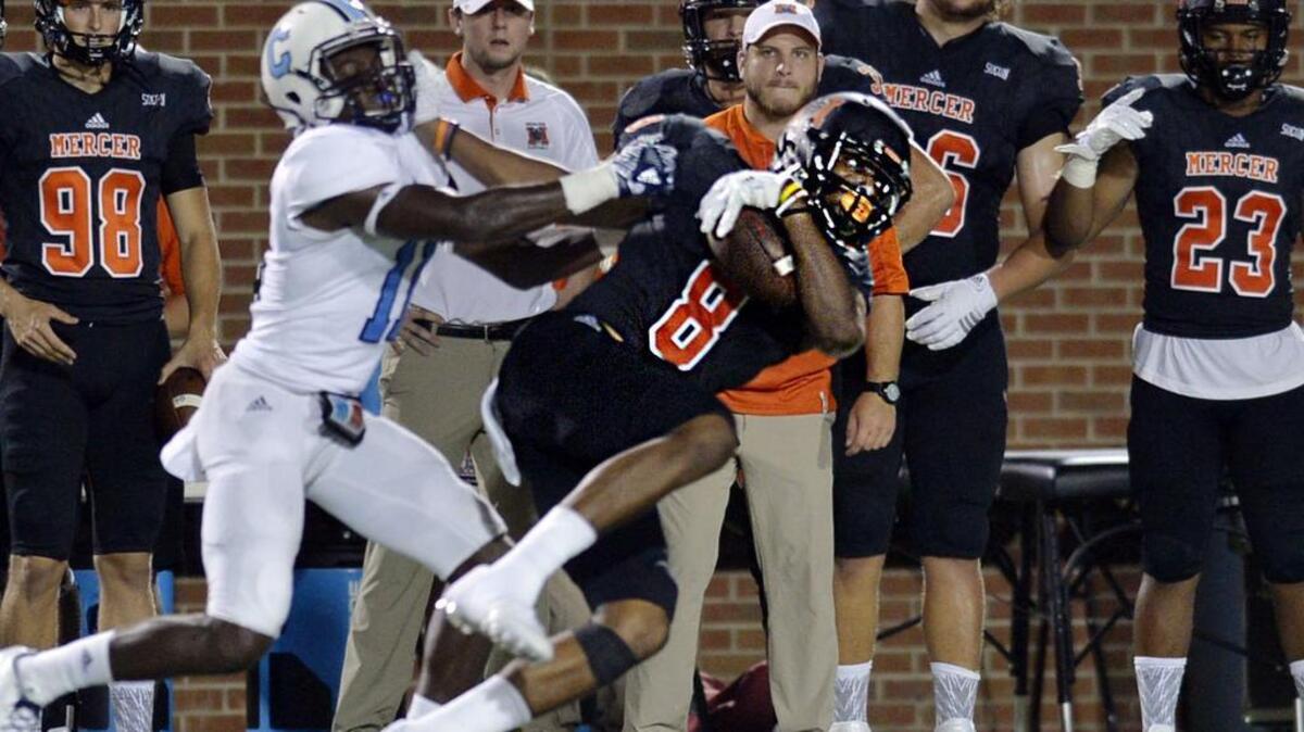 Citadel defensive back Ben Roberts (11) tries to keep Mercer receiver Marquise Irvin from a first down in the second half on Thursday.