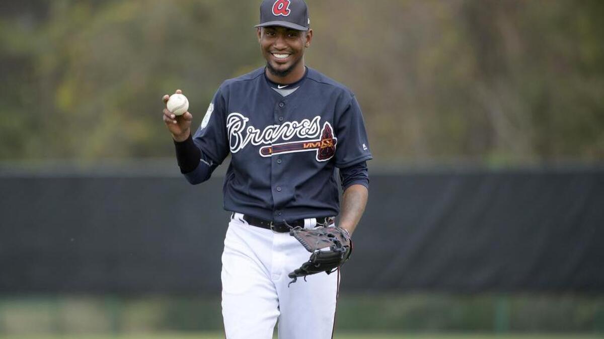 Atlanta Braves pitcher Julio Teheran warms up during the first full-squad spring training workout in Lake Buena Vista, Fla., Saturday, Feb. 18, 2017.