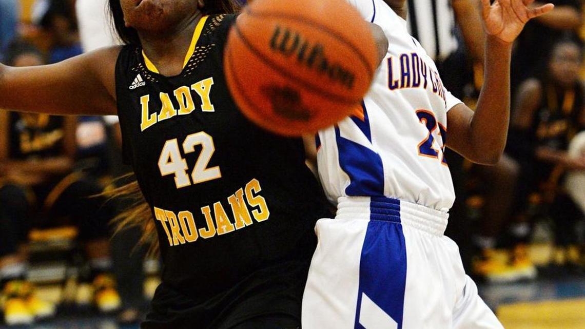 Peach County's Ilesha Pickens (42) battles Central's JeNya Wilder (22) for a rebound during second half action against Peach County.