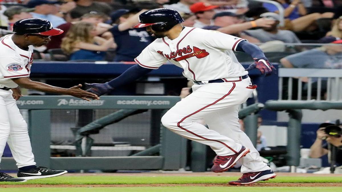 Atlanta Braves' Matt Kemp, right, high-fives third base coach Ron Washington after hitting a home run in the third inning of a baseball game against the Washington Nationals in Atlanta, Friday, May 19, 2017.