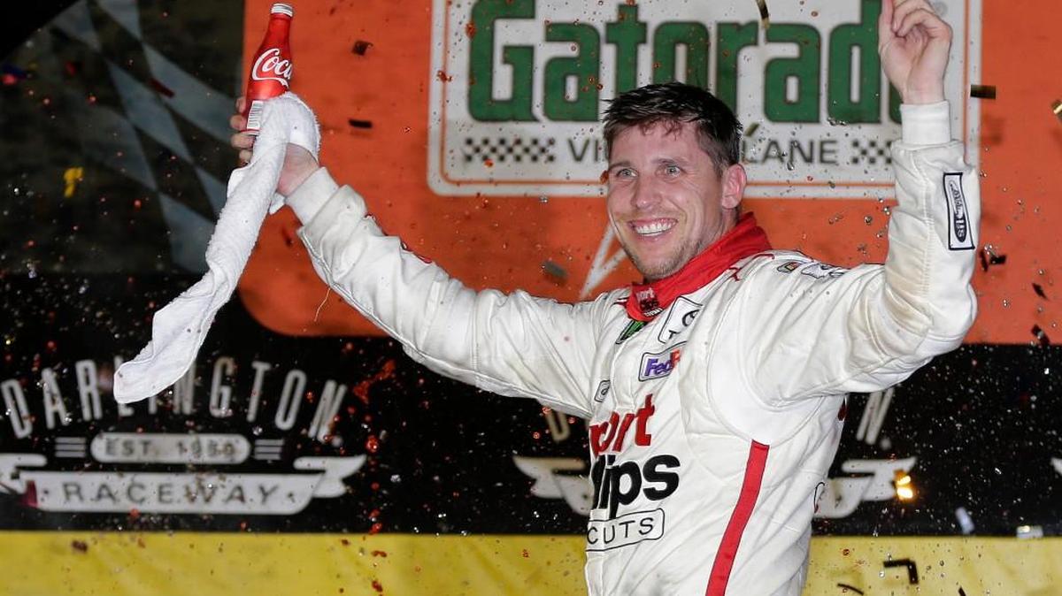 Denny Hamlin celebrates in Victory Lane after winning the NASCAR Monster Cup auto race at Darlington Raceway, Sunday, Sept. 3, 2017, in Darlington, S.C.