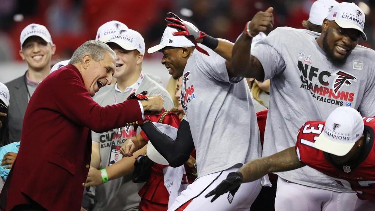 Atlanta Falcons owner Arthur Blank dances on stage with his players after beating the Green Bay Packers 44-21 in the NFC championship game Sunday.