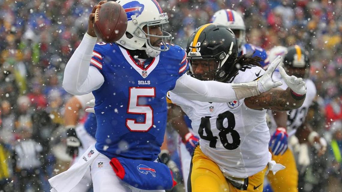Buffalo Bills quarterback Tyrod Taylor (5) looks to pass as Pittsburgh Steelers outside linebacker Bud Dupree (48) chases him during the first half of an NFL football game, Sunday, Dec. 11, 2016, in Orchard Park, N.Y.