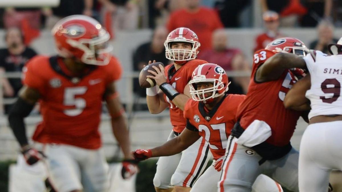 Georgia quarterback Jake Fromm (11) looks downfield as receiver Terry Godwin (5) goes long for the bomb and the first score of the Bulldogs' game against Mississippi State.