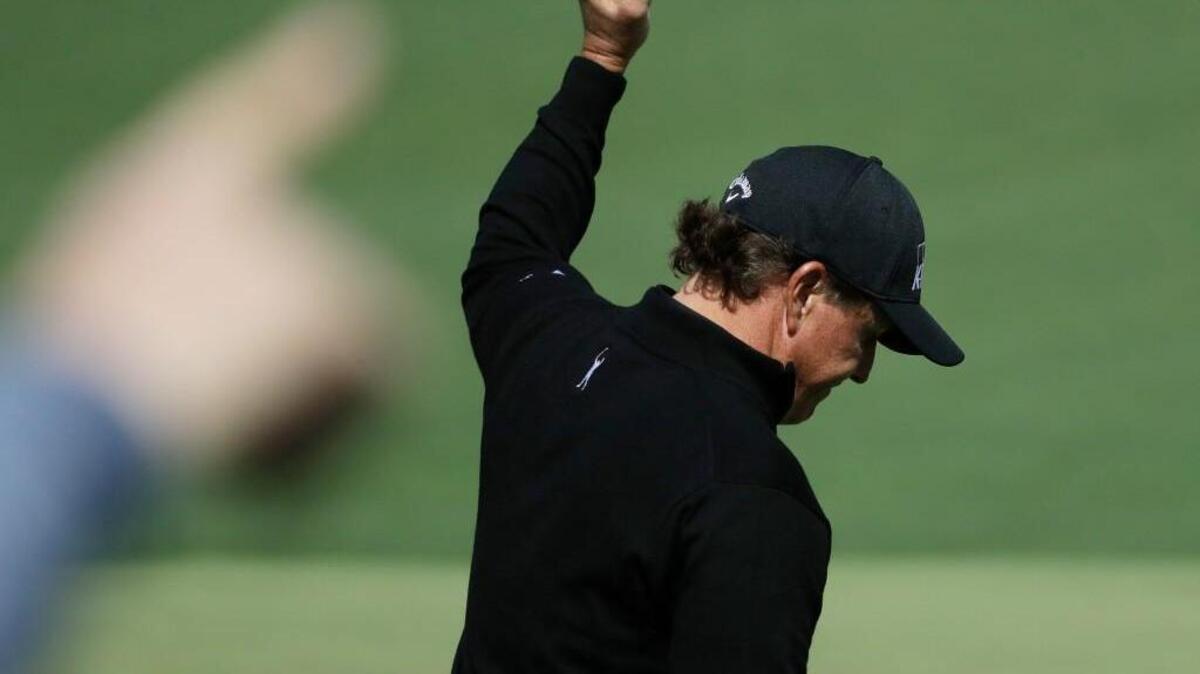 Phil Mickelson reacts after making an eagle on the second hole during the first round for the Masters golf tournament Thursday.