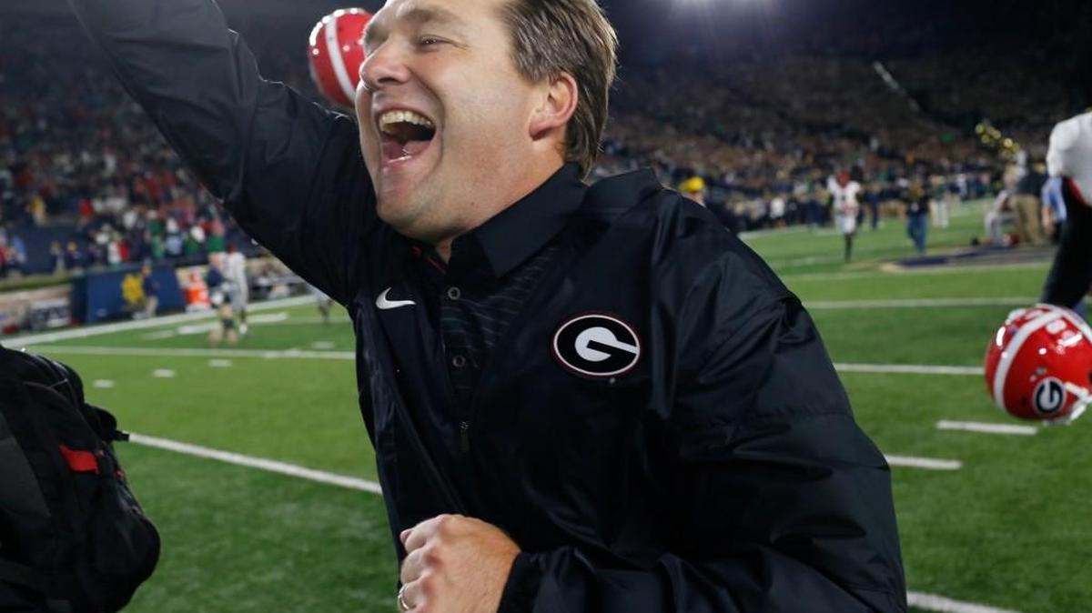 Georgia Kirby Smart runs to celebrate with fans after the team's win over Notre Dame on Saturday.