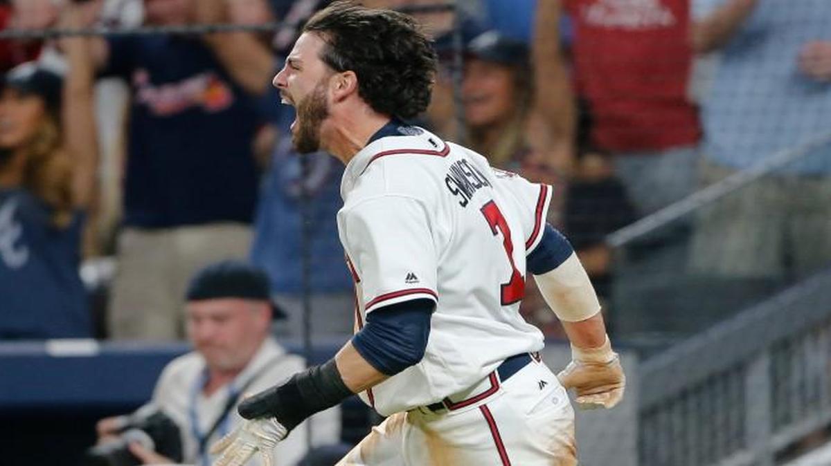 Atlanta’s Dansby Swanson (7) yells after scoring the game-winning run on a Rio Ruiz base hit during the ninth inning of Friday’s game against the New York Mets.