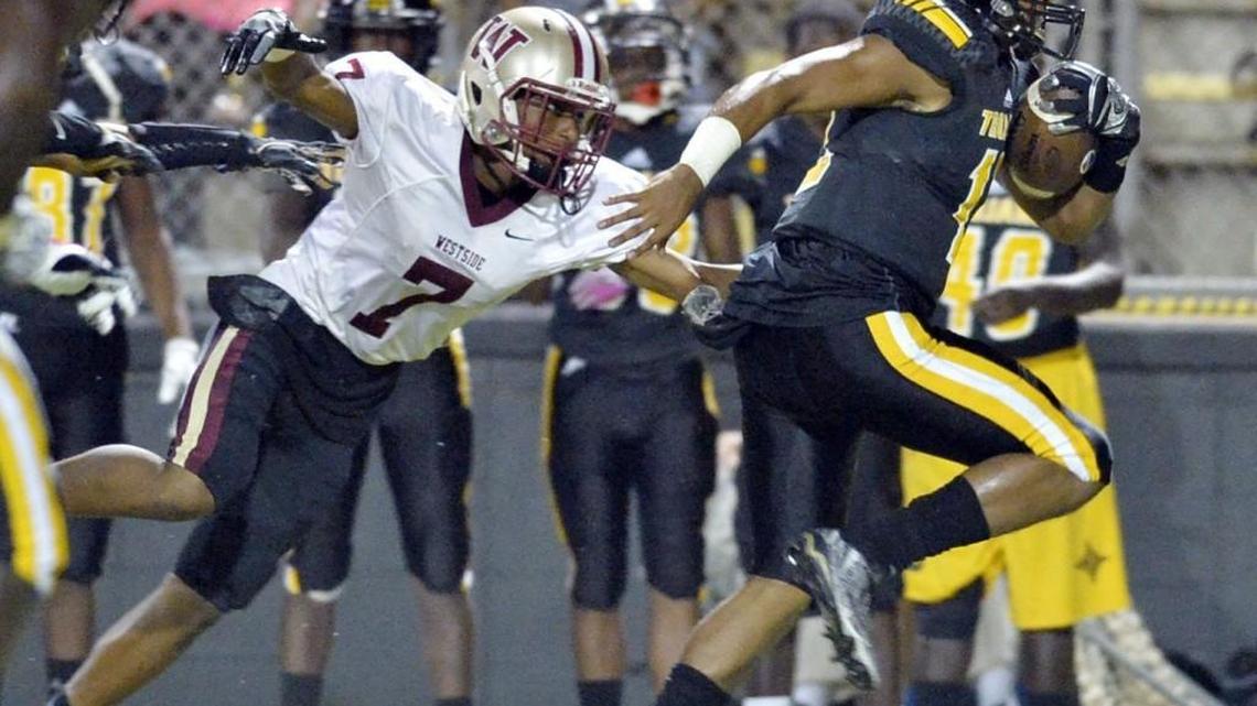 Westside cornerback Mystikal Wilson (7) was the last man to touch Peach County quarterback Antonio Gilbert (12) as he headed for a long touchdown run in the first half giving the Trojans a 17-0 lead.