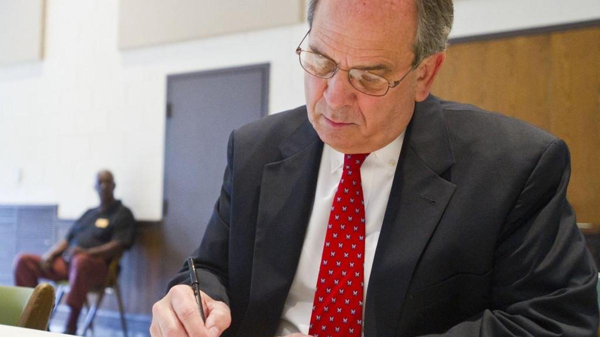 Mayor Robert Reichert fills out the form to vote at Northminster Presbyterian Church on Tuesday morning.