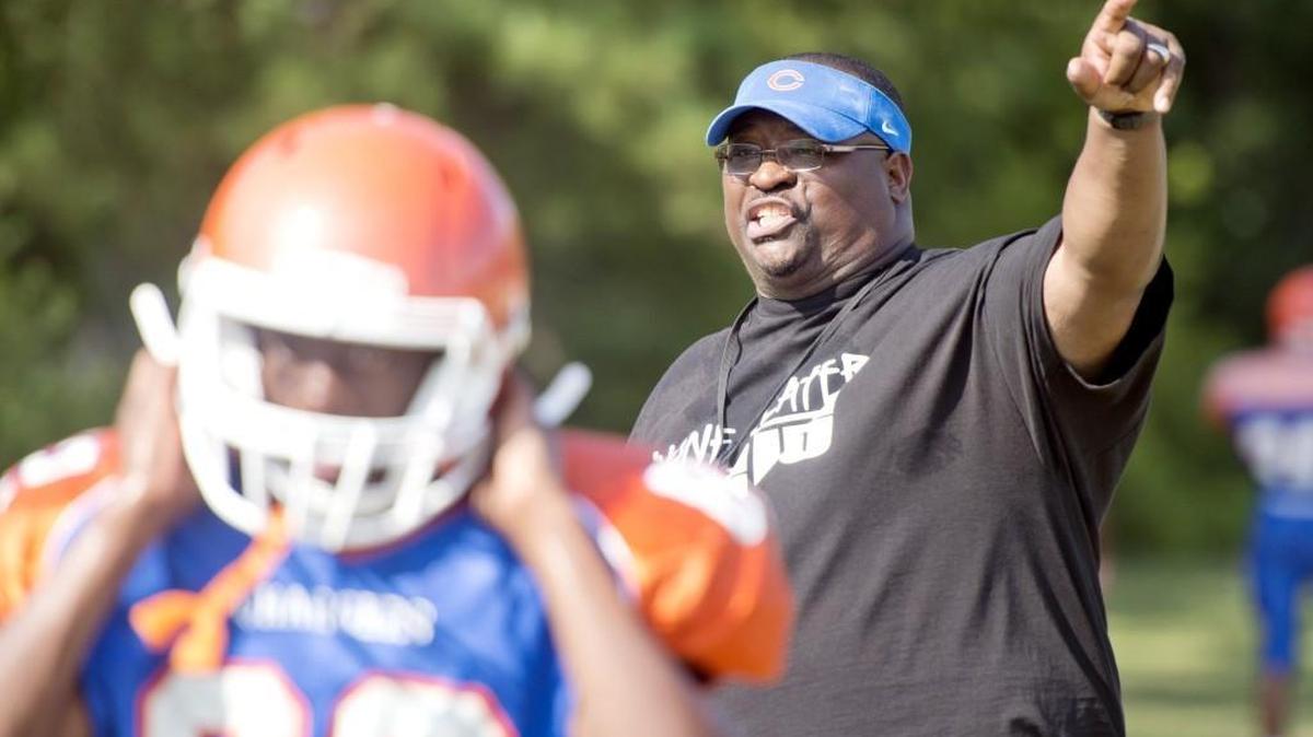 Central football head coach Jesse Hicks instructs his team after a water break during practice August 3.
