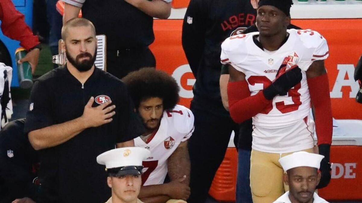 San Francisco quarterback Colin Kaepernick (7) kneels during the national anthem before the team’s Sept. 1 preseason football game against San Diego.