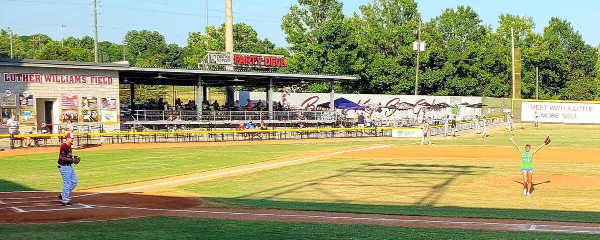 Macon Pride VP Charlotte Renee Storey celebrates after throwing out the first pitch during the Bacon’s Pride Night on Wednesday.