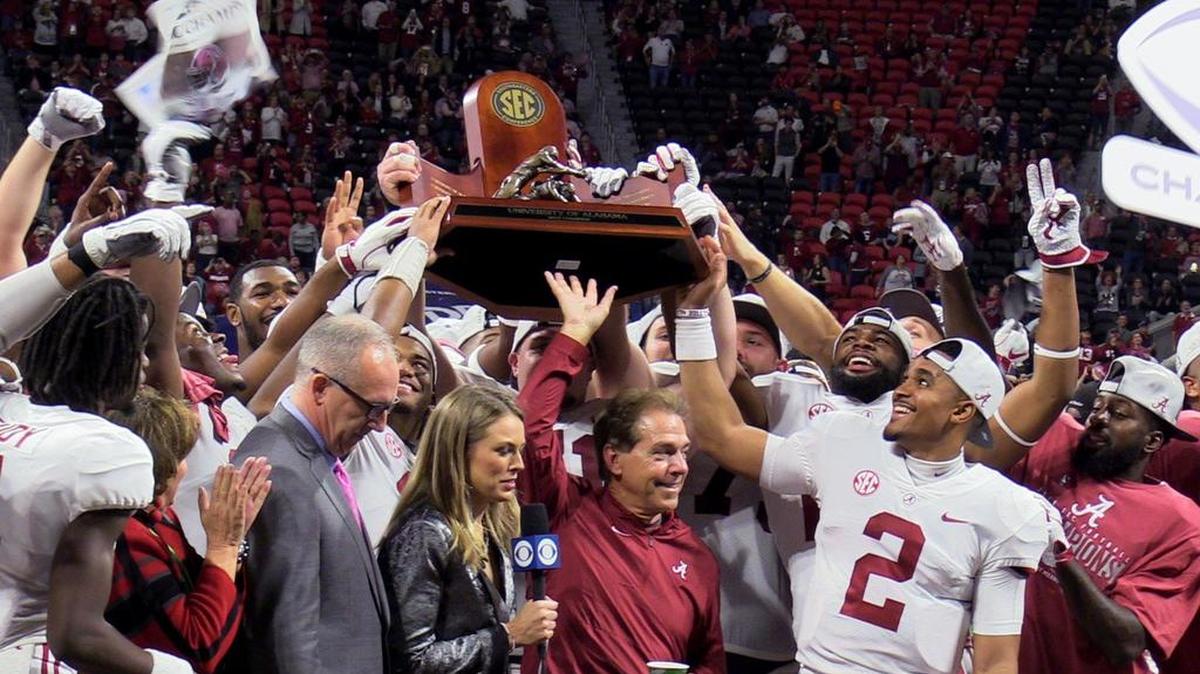 Alabama players and head coach Nick Saban celebrate their 35-28 SEC Championship win over Georgia.