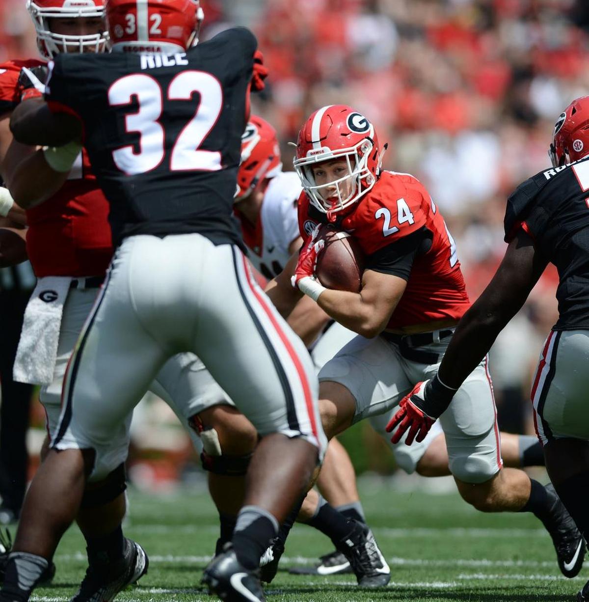 Red team tail back Prather Hudson (24) carries to set up the first touchdown of the G-Day Game.